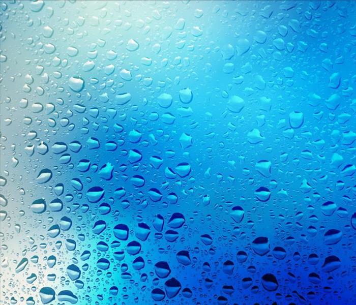 moisture driplets on a window, blueish